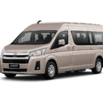 Toyota Hiace Premio coklat muda metallic tampak serong depan dan samping untuk layanan sewa Hiace Jakarta dengan driver profesional